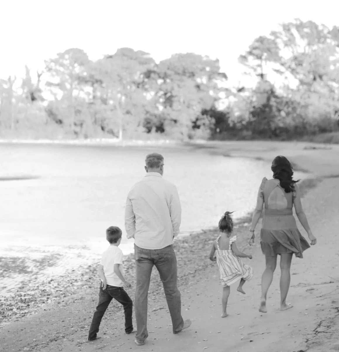 Scott and his family walking barefoot along the beach.